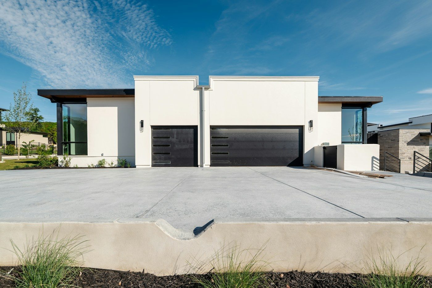 Modern white home with a wide concrete driveway