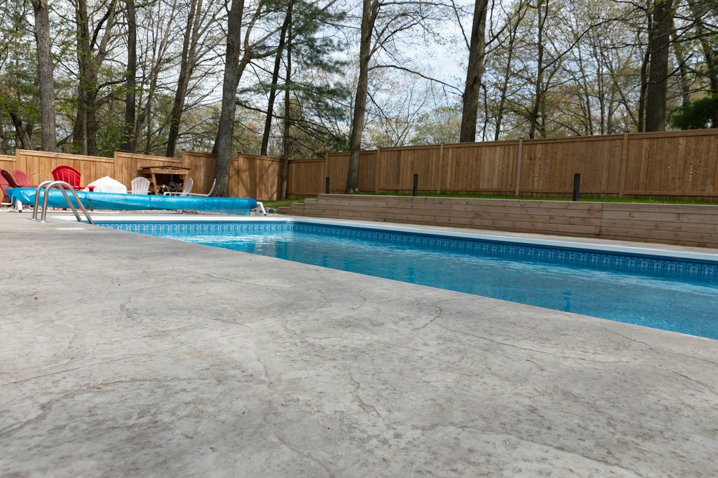 Concrete patio and pool surround in a backyard